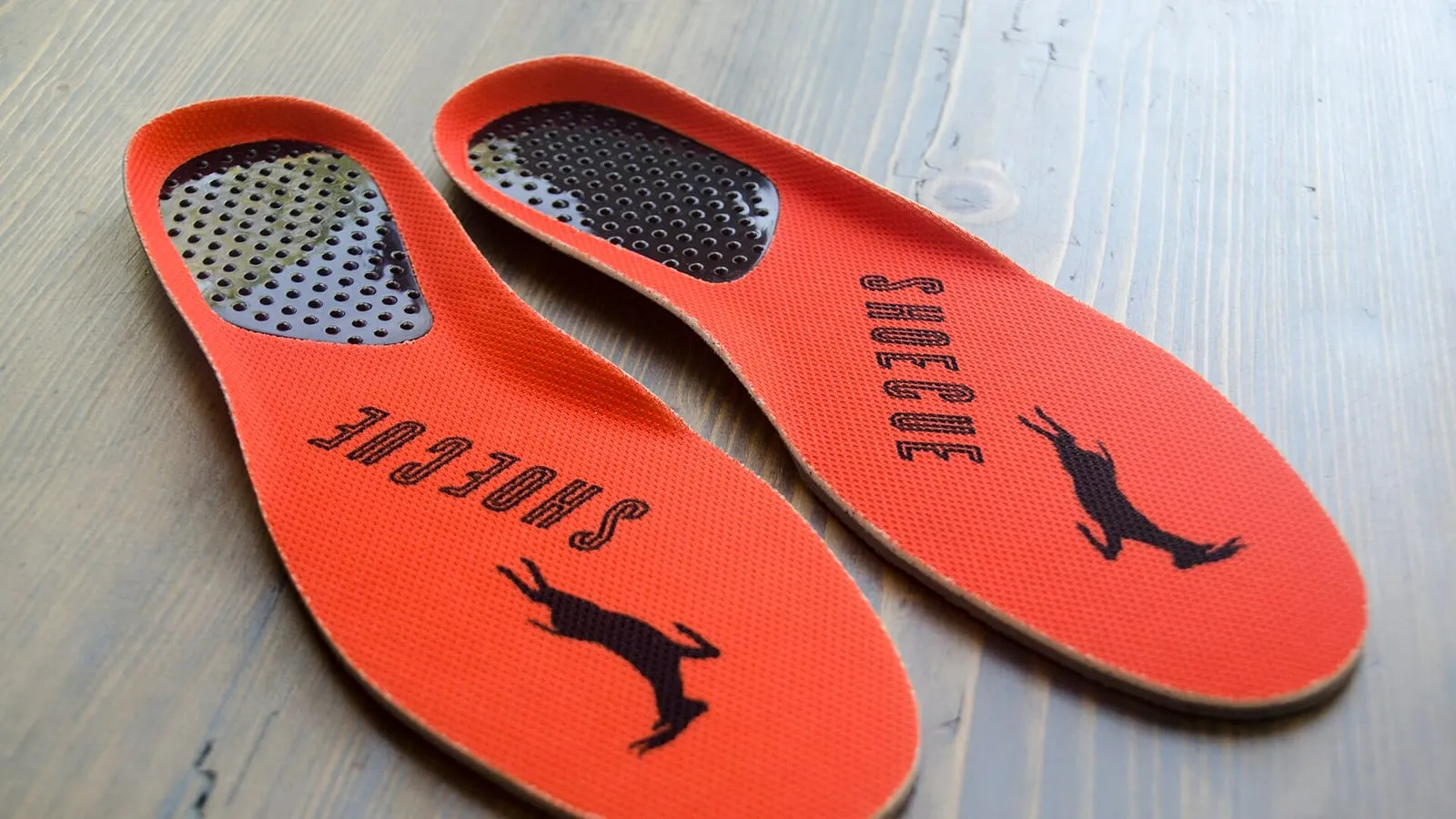 A pair of insoles showing the raised arch and heel pad